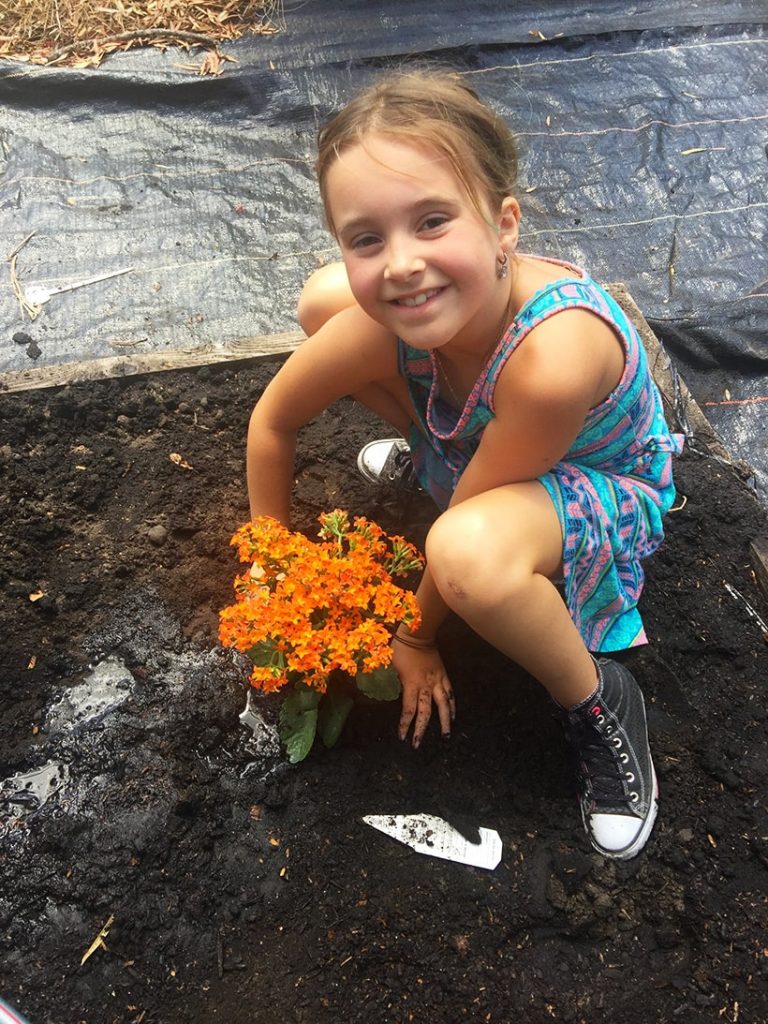 little girl planting flowers